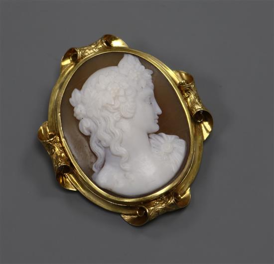 A yellow metal mounted oval cameo brooch, carved with the bust of a lady to sinister, 43mm.